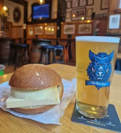 A cheese cob and a pint in a Blue Boar glass